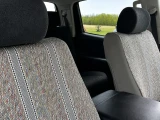 Saddle Blanket seat covers on front buckets, heathered grey weave with vertical stripe sets and solid grey sides.