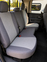 OEM seat covers on rear bench, gray bolsters and headrests with light gray honeycomb mesh on backrest and cushion.