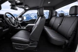 Black Pro-Tect Vinyl Seat Covers installed in a truck, durable full-coverage protection for front and rear seats.