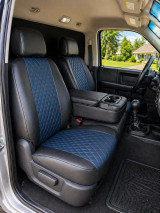 Imitation leather seat covers on truck front buckets with console, black bolsters and navy blue diamond-quilted inserts.