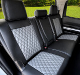 Imitation Leather seat covers on rear bench with three headrests, black bolsters and gray diamond-quilted center inserts.