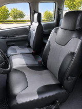 Imitation Leather seat covers on front buckets, black bolsters with curved light gray center panels on both seats.