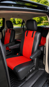 Imitation Leather seat covers on minivan second-row captain chairs, red centers with black bolsters and vertical stitching.