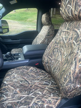 Mossy Oak Waterproof Camo Seat Covers installed on front seats in a truck with waterfowl reeds camo pattern.