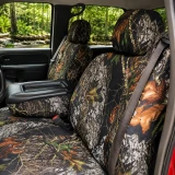 Mossy Oak Waterproof Camo seat covers on front buckets and console, forest camo with bark, leaves, and branches.