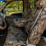 Mossy Oak Waterproof Camo Seat Covers installed on a front bench seat with fold-down console in woodland camo.
