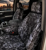 Moon Shine Waterproof Camo seat covers on truck 40/20/40 bench, black-and-white branch camo on seats, console, and headrests.