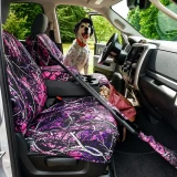 Moon Shine seat covers on truck front seats, pink-purple branch camo with matching case and dog in driver seat.