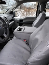 Atomic Pro-Tect seat covers in solid medium gray on Ford front buckets, headrests, and fold-down console with cupholders.