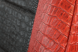 Close-up of Exotic Seat Covers showing the detailed red and black crocodile skin embossed texture and durable fabric and stitching.