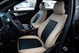 Exotic Seat Covers on front seats, tan ostrich texture with black inserts for a custom-fit luxury interior.