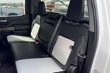 Exotic Seat Covers on rear bench seat, black and light gray custom-fit protection with center console access.