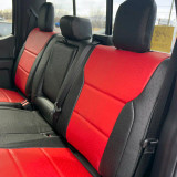 Rear bench seat of a truck protected by two-tone exotic seat covers featuring a textured Black Ostrich finish on the outer edges and a vibrant Red Ostrich insert in the center, providing a sporty and high-end look.