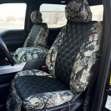 Luxury Line Kryptek camo seat covers shown on front buckets with console, scale camo and black diamond-quilted inserts.