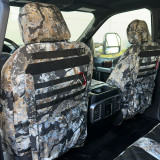 Luxury Line Kryptek camo seat covers on seat backs with black MOLLE, Velcro patch strip, base pockets, earth-tone scale camo.