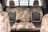 Luxury Line Kryptek camo seat covers on full rear bench, triple headrests, armrest, Highlander and black quilted inserts.