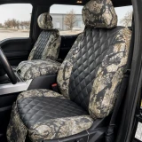 Luxury Line Kryptek camo seat covers shown on front buckets with console, scale camo and black diamond-quilted inserts.