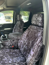 Luxury Line Moon Shine Seat Covers installed in a truck, featuring a full-coverage branch camo pattern and tailored fit.