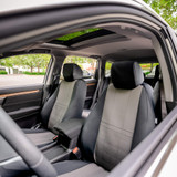 NeoSupreme Seat Covers installed on front seats in an SUV, two-tone black and gray fabric with a custom-fit finish.
