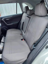 Full rear bench seat outfitted with solid charcoal NeoSupreme seat covers, providing complete protection while maintaining access to all seat functions.