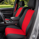 NeoSupreme seat covers on front buckets, red centers with black bolsters and headrests, vertical stitching, red seatbelts.