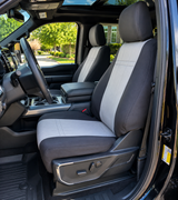 NeoSupreme seat covers on truck front buckets, charcoal bolsters with light gray stitched centers and black headrest wraps.