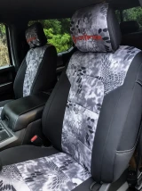 Front bucket seats with custom-fit Kryptek® seat covers in a grey and white "Raid" camo pattern, accented by black side bolsters for a sporty, rugged look.