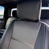 Close-up of Luxury Line Carbon Fiber Seat Covers showing the premium carbon fiber textured insert and a snug custom-fit headrest.