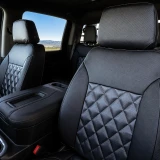 Luxury Line Carbon Fiber Seat Covers on front truck seats, featuring charcoal carbon fiber inserts with a quilted diamond stitch pattern.
