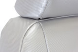Detailed view of Luxury Line Carbon Fiber Seat Covers showing the snug custom fit of the headrest in light gray.