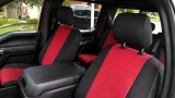 Front seats of a pickup truck outfitted with red and black two-tone CORDURA® 1000 Denier seat covers, providing heavy-duty protection and a custom-tailored appearance.