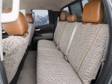Rear bench seat of Luxury Line Saddle Blanket Seat Covers, durable woven fabric with brown leatherette headrests.