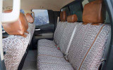 Rear bench seat of Luxury Line Saddle Blanket Seat Covers, durable woven fabric with brown leatherette headrests.