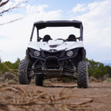 Front view of a white Yamaha side-by-side vehicle outdoors, highlighting its rugged design and off-road capability.