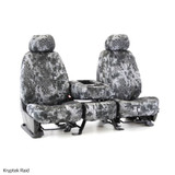 Front bucket seats and center console with Kryptek Raid camo seat covers, offering a custom-fit tactical look.