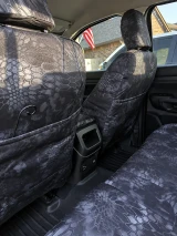 Kryptek Waterproof seat covers on front seat backs and rear bench, grey-black Typhon camo with map pockets.
