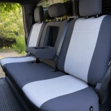 Neoprene seat covers on rear bench, charcoal sides with light gray grid panels, headrests, and fold-down armrest cover.