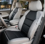 Sof-Touch Leatherette seat covers on front buckets, light gray with perforated black stitched panels and matching console.