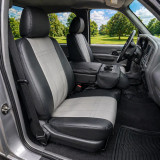 Imitation leather seat covers shown on front bucket seats with armrest, black sides and light gray stitched panel inserts.