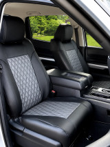 Imitation Leather seat covers on rear bench with three headrests, black bolsters and gray diamond-quilted center inserts.