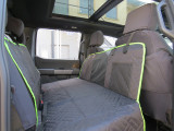 Universal Pet Seat Cover hammock on front headrests, diamond-quilted charcoal with center mesh panel and lime trim.