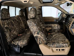 Side profile of a crew cab truck interior with custom-fit Realtree Camo seat covers installed on both rows, highlighting a seamless and tailored fit.