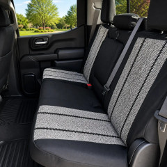 Saddle Blanket seat covers on truck rear bench, grey salt-and-pepper weave with black stripes, black bolsters, and armrest.