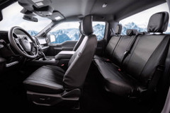 Black Pro-Tect Vinyl Seat Covers installed in a truck, durable full-coverage protection for front and rear seats.