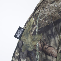 Close-up of Mossy Oak Waterproof Camo Seat Covers showing “Side Airbag” compatibility tag on camo fabric.