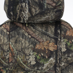 Close-up of Mossy Oak Waterproof Camo Seat Covers showing camo pattern on seatback and headrest area.