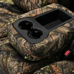 Mossy Oak Waterproof Camo Seat Covers console cover close-up showing cupholders and storage bin opening with camo trim.
