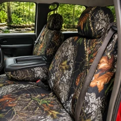 Mossy Oak Waterproof Camo seat covers on front buckets and console, forest camo with bark, leaves, and branches.