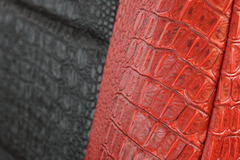 Close-up of Exotic Seat Covers showing the detailed red and black crocodile skin embossed texture and durable fabric and stitching.