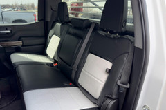 Exotic Seat Covers on rear bench seat, black and light gray custom-fit protection with center console access.